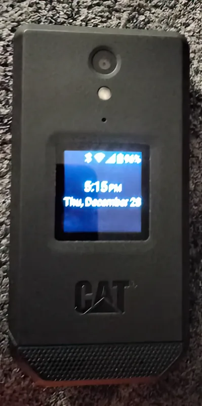 The cover display lit in low light with the phone shut