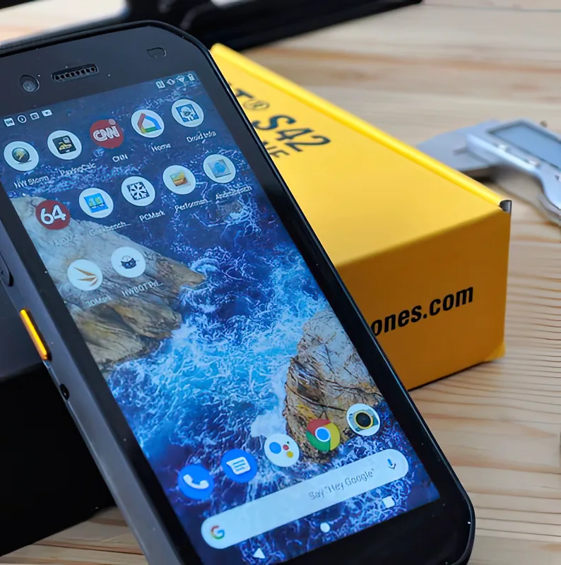 Beside the yellow retail box, with benchmark apps on screen