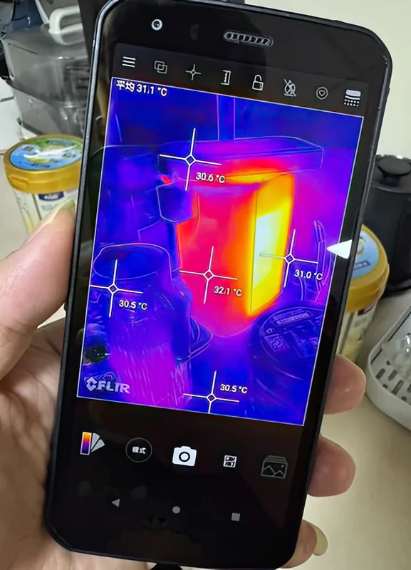 The FLIR app reading several spot temperatures at once on a kitchen appliance