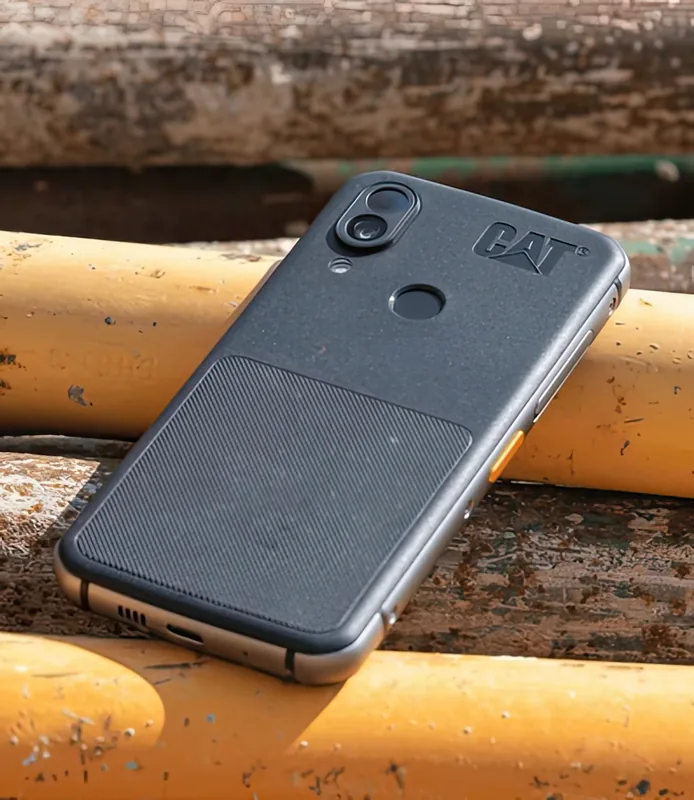 Resting on painted steel pipe — the orange programmable key is visible on the edge