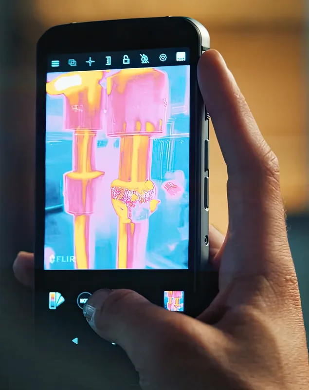 Scanning plumbing with the thermal camera, held in one hand