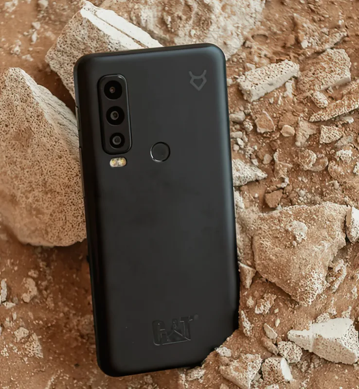 Lying on broken concrete — the environment this phone is built for