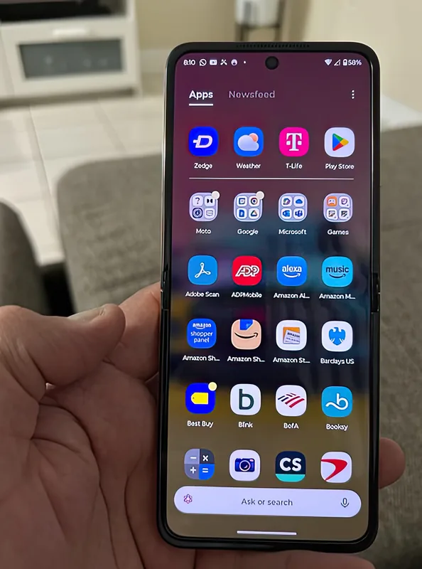 Held open in one hand with the app drawer on screen