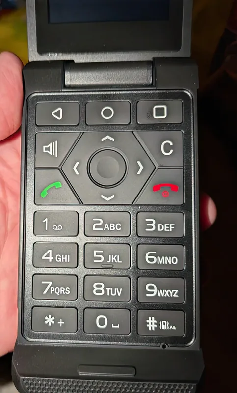 The keypad and navigation cluster close up, held in one hand