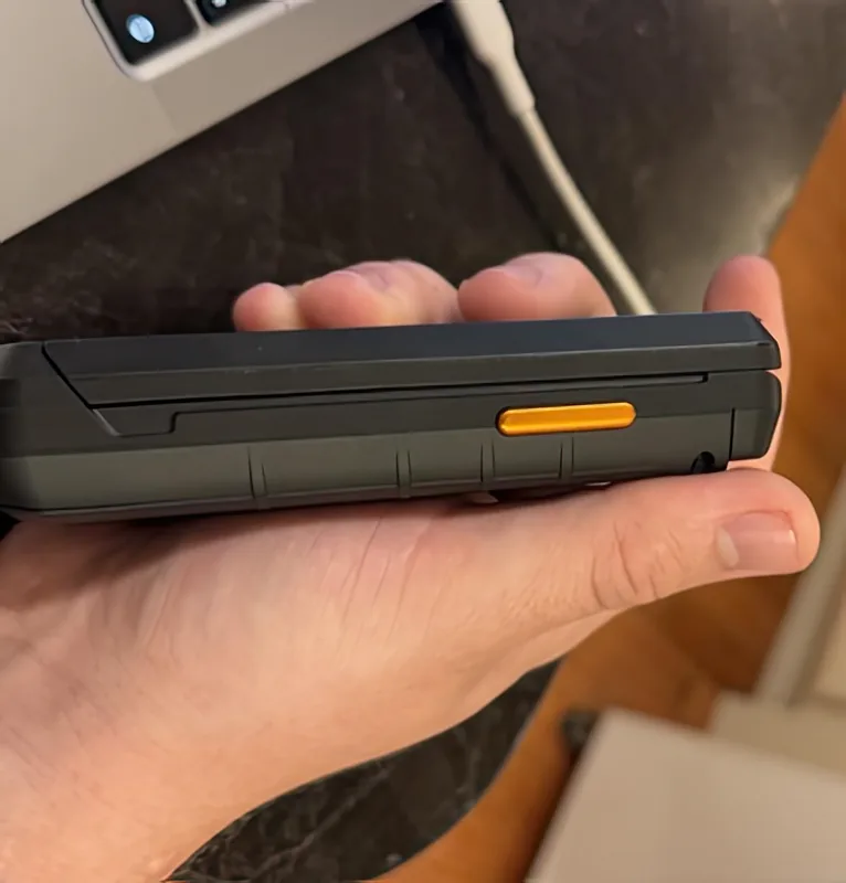 The side of the phone, with the orange programmable key